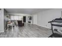 Spacious living room with hardwood floors and a modern fireplace at 6355 W Caron St, Glendale, AZ 85302