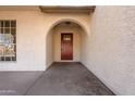 Red front door entryway with arched entry and sidelights at 7101 W Laurel Ln, Peoria, AZ 85345