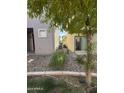 Small side yard with gravel and some shrubs at 7309 S 17Th Dr, Phoenix, AZ 85041