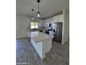 Bright kitchen featuring an island and white cabinets at 8306 W Swansea Dr, Arizona City, AZ 85123