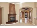 Elegant corner fireplace with dark wood mantel and decorative finish at 8911 E Rusty Spur Pl, Scottsdale, AZ 85255