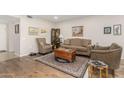 Living room features hardwood floors and neutral decor at 9403 W Fern Dr, Sun City, AZ 85351