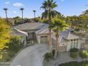 Beautiful single-story home featuring a circular driveway and well-maintained landscaping with mature palm trees at 953 E Fieldstone Pl, Chandler, AZ 85249