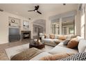 Cozy living room with fireplace, plush sofa, coffee table and bright natural light at 953 E Fieldstone Pl, Chandler, AZ 85249