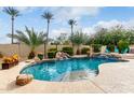 Beautiful backyard pool area with waterfall feature and lush landscaping at 953 E Fieldstone Pl, Chandler, AZ 85249