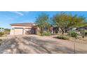 Landscaped front yard and attached three-car garage at 9740 E Lofty Point Rd, Scottsdale, AZ 85262