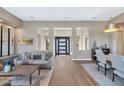 Open living space with hardwood floors, neutral tones, and a view to the entryway at 9740 E Lofty Point Rd, Scottsdale, AZ 85262