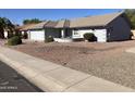 Front view of a single-story house with gravel landscaping at 10840 E Keats Ave, Mesa, AZ 85209