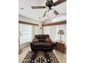 Relaxing living room with a brown leather couch and a ceiling fan at 1448 S Zuni --, Apache Junction, AZ 85119