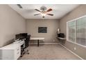 Bright home office features built-in shelving and window at 17482 W Pinnacle Vista Dr, Surprise, AZ 85387