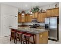 Kitchen with island, stainless steel appliances, and wood cabinets at 1971 E Yellowstone Pl, Chandler, AZ 85249