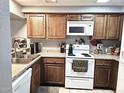 Functional kitchen with white appliances, wood cabinets, and plenty of counter space at 2121 W Union Hills Dr # 115, Phoenix, AZ 85027