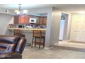 Comfortable living room showcases a breakfast bar with seating, connecting the living space to the kitchen at 2121 W Union Hills Dr # 115, Phoenix, AZ 85027
