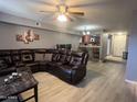 Inviting living room featuring a large, comfortable leather sectional and an open floor plan at 2121 W Union Hills Dr # 115, Phoenix, AZ 85027
