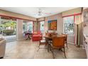 Bright dining area with a round table and leather chairs, adjacent to the living room at 21364 N Redington Point Dr, Surprise, AZ 85387