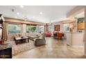 Spacious living room featuring a large sectional sofa and tile flooring at 21364 N Redington Point Dr, Surprise, AZ 85387