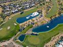 Stunning aerial view of a golf course community with lakes at 23335 N Country Club Trl, Scottsdale, AZ 85255