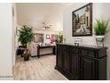 Bright entryway with dark wood cabinet and view of living room at 2523 E Taro Ln, Phoenix, AZ 85050