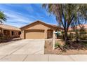 Single story home featuring a beige exterior, 2-car garage, tile roof and low maintenance landscaping at 2716 W Allens Peak Dr, San Tan Valley, AZ 85144