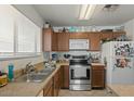 Kitchen features wood cabinets, stainless steel appliances, and double sink at 2716 W Allens Peak Dr, San Tan Valley, AZ 85144