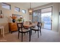 Dining area with a wooden table and access to the backyard at 41226 N Rolling Green Way, Anthem, AZ 85086