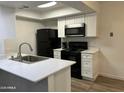 Modern kitchen with white cabinets and black appliances at 520 N Stapley Dr # 290, Mesa, AZ 85203