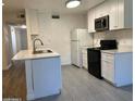 Modern kitchen with white cabinets and new appliances at 5236 W Peorioa Ave # 137, Glendale, AZ 85302