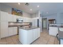 Kitchen with island, stainless steel appliances, and white cabinets at 5363 S Emerald Desert Dr, Gold Canyon, AZ 85118