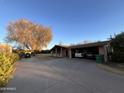 Two-car garage with large backyard and mature trees visible at 551 S Esquire Way, Mesa, AZ 85202