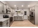 Modern kitchen with stainless steel appliances and light cabinets at 5715 N 105Th Ln, Glendale, AZ 85307