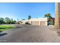 Large home with a three-car garage and paved driveway at 7032 E Dreyfus Ave, Scottsdale, AZ 85254