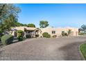 This home features a large paved driveway and nicely landscaped grounds at 7032 E Dreyfus Ave, Scottsdale, AZ 85254