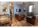 Open living and dining area with hardwood floors and leather furniture at 9233 E Neville Ave # 1131, Mesa, AZ 85209