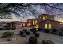 Two-story home with a three-car garage and desert landscaping at 10855 E Elba Way, Scottsdale, AZ 85262