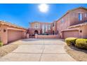 Three-car garage, two-story home with stucco siding and desert landscaping at 10855 E Elba Way, Scottsdale, AZ 85262