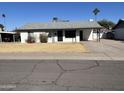 Charming single-story home featuring a spacious driveway, xeriscaped yard, and a covered front patio at 1410 E Bishop Dr, Tempe, AZ 85282