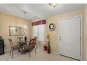 Small dining area with glass table and four chairs at 14950 W Mountain View Blvd # 4305, Surprise, AZ 85374