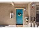 Teal front door with wreath and potted plants at 14950 W Mountain View Blvd # 4305, Surprise, AZ 85374