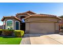 Single-story home with a two-car garage and nicely landscaped front yard at 15415 S 37Th Pl, Phoenix, AZ 85044