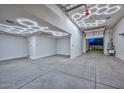 Extravagant garage with hexagon LED lighting and epoxy flooring at 16871 W Cielo Grande Ave, Surprise, AZ 85387