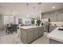 Modern kitchen with gray cabinets, white countertops, and an island at 17058 W Seldon Ln, Waddell, AZ 85355