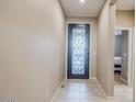 Bright entryway with tiled floors and an ornate front door at 18055 W Muirwood Dr, Goodyear, AZ 85338