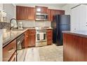 Modern kitchen with stainless steel appliances and dark wood cabinets at 1880 E Morten Ave # 206, Phoenix, AZ 85020