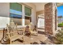 Relaxing front porch with rocking chairs and brick columns at 21002 E Mayberry Rd, Queen Creek, AZ 85142