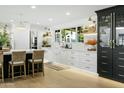 Modern kitchen features white cabinets, marble countertops, and a large island at 2246 E Bethany Home Rd, Phoenix, AZ 85016