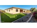 Artificial turf and a covered patio in the backyard at 22643 E Stonecrest Dr, Queen Creek, AZ 85142