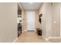 Interior entryway with tile flooring, bench, and coat rack at 25969 W Tina Ln, Buckeye, AZ 85396