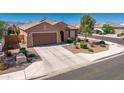 Charming single-story home featuring a two-car garage, desert landscaping, and a tile roof at 25969 W Tina Ln, Buckeye, AZ 85396