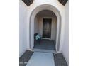 Covered entryway with arched entry and decorative bench at 26035 W Quail Ave, Buckeye, AZ 85396