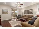 Living room with hardwood floors, a sofa, and access to a patio at 26541 W Ross Ave, Buckeye, AZ 85396